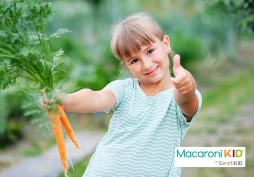 PRO Little Girl Picking Carrots in a Garden