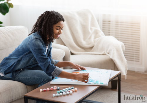 happy woman painting at home