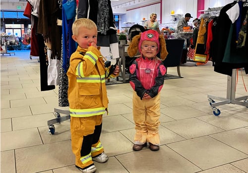 two children in halloween costumes at the halloween bootique
