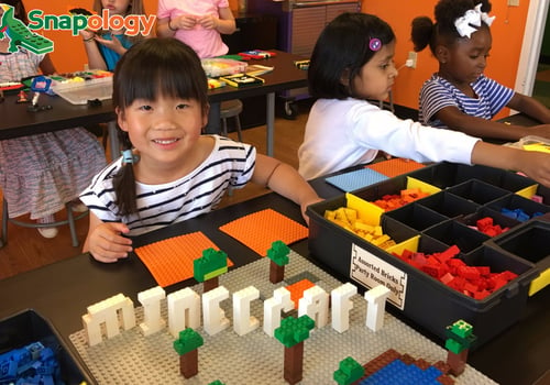 Girl building with LEGO bricks