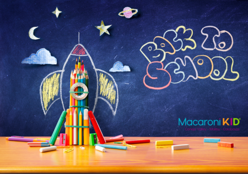 Back to School written in colored chalk with a space ship made with art supplies