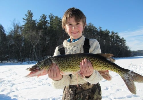 boy with fish; lake; winter; ice-fishing