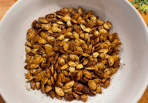 Roasted pumpkin seeds in a white bowl