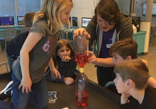 kids and an instructor doing science