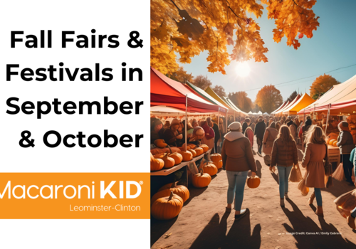 Shows a group of people walking by tents at a fair with pumpkins during a fall sunset