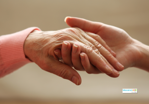 young person holding an elderly person's hand