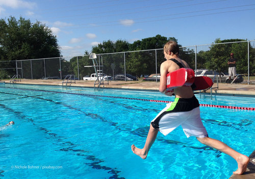 lifeguard jumping in pool