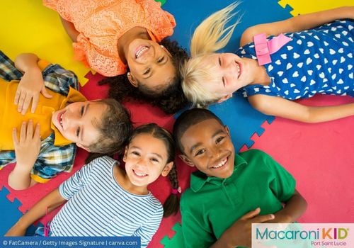 Diverse Happy Kids laying head-to-head on a mat looking up
