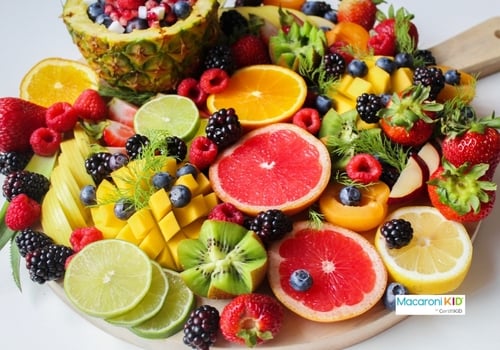 Colorful plate of different kinds of cut fruit