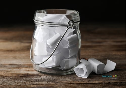 Glass Jar with Paper Pieces on Wooden Table