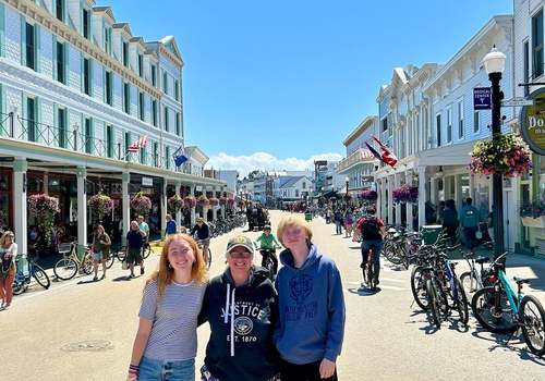 mom and two teens in road on mackinac island