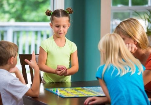 Kids and Mom playing board game
