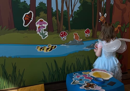 Child putting magnets on a wall