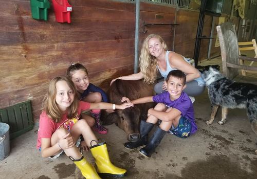 Katy Goat Yoga kid's classes and Summer Camps. Kids with a cow in Katy Texas