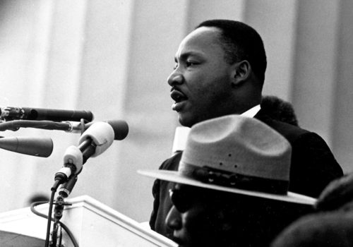 Martin Luther King Jr. at the microphone giving a speech at the March on Washington