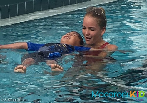 Young boy taking swimming lessons