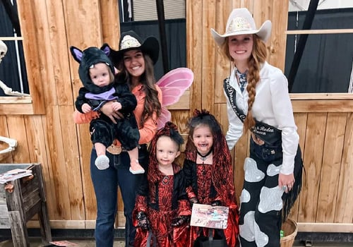 family in costumes posing for a picture at the 2nd annual ghost town hoedown