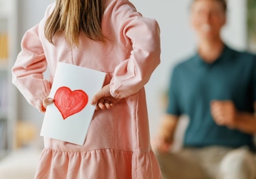 Girl offers Valentine's Day card to her Dad