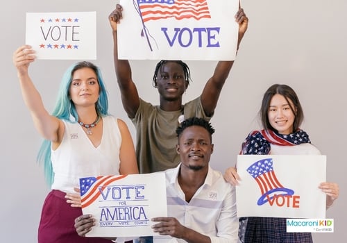 Group of people holding signs about voting