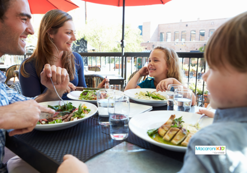 family eating outdoors at restaurant