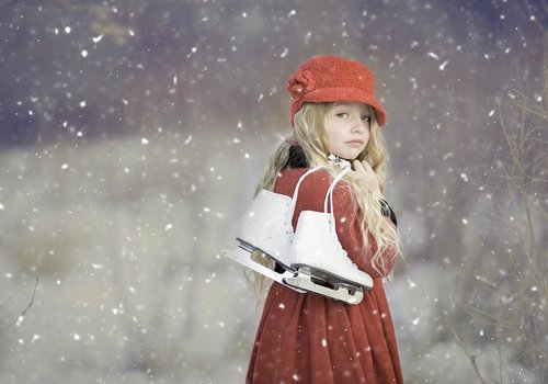 Girl with ice skates in snow