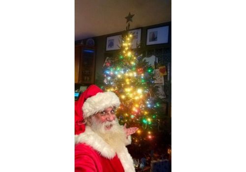 Santa in front of tree