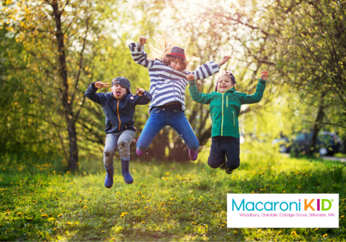 Three kids jumping in the air in the forest