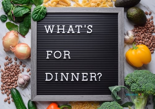 What's for dinner sign on letter board surrounded by food