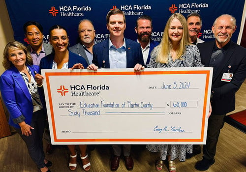 Education Foundation of Martin County Staff holding large 60K check donated by HCA Florida Healthcare