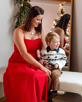 Jennifer in a red dress and her son Liam for Christmas 2024