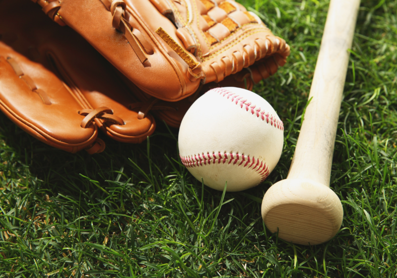 Baseball, bat and glove on grass