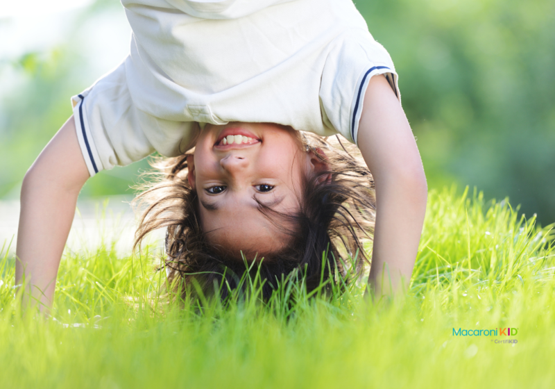Happy Kid playing outside in grass