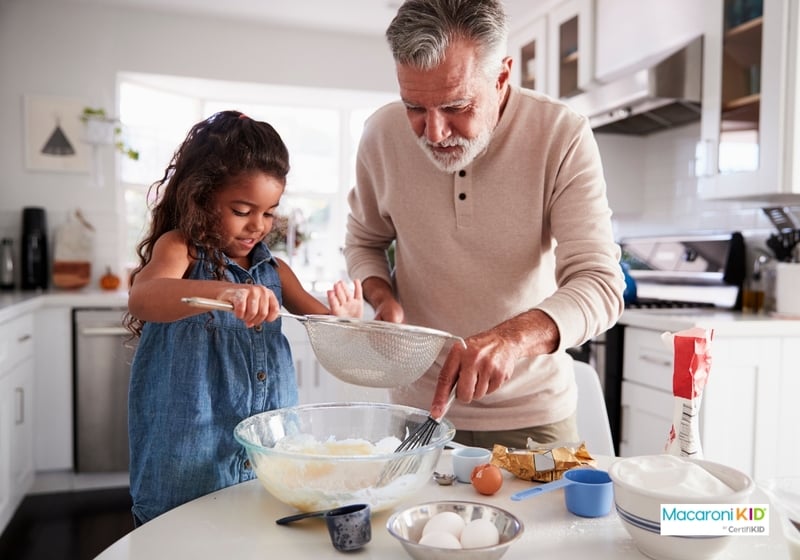 Girl baking with granfather