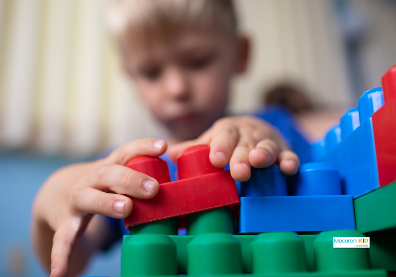 kid building with building blocks