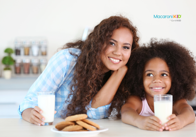 Mother and Daughter with plate of cookies and glasses of  milk