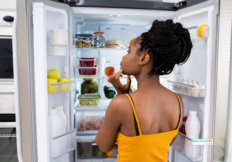 woman looking in fridge with thanksgiving leftovers