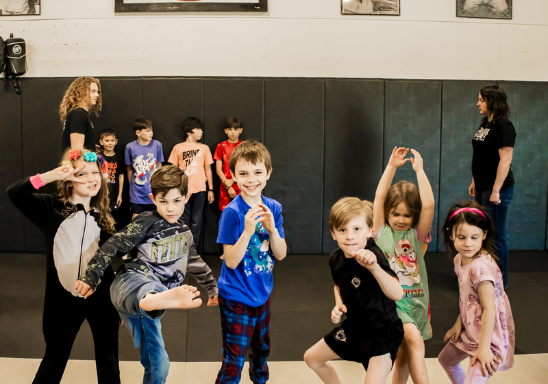 Group of children doing fun ninja-like poses at Lionheart MMA & Fitness in Moncks Corner, SC