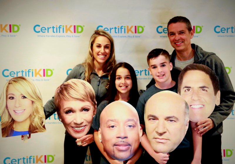 Jamie and Brian Ratner, and kids with headshots of Shark Tank judges