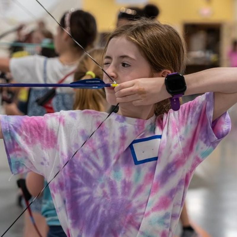 Child shooting a bow and arrow