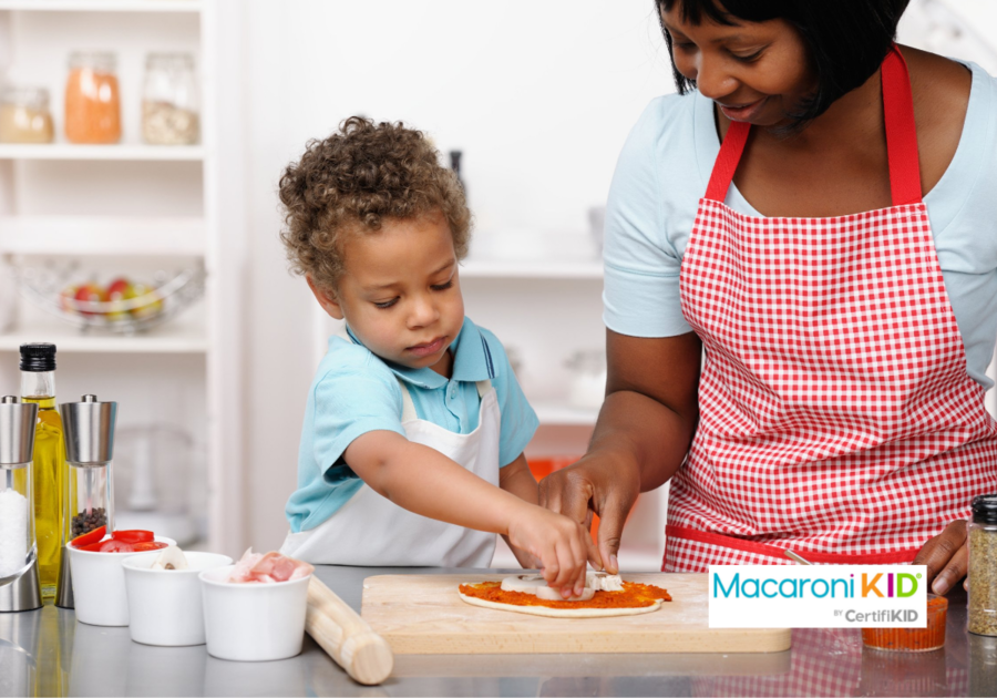 Little Boy/ Toddler And Carer/ Parent Preparing Pizza