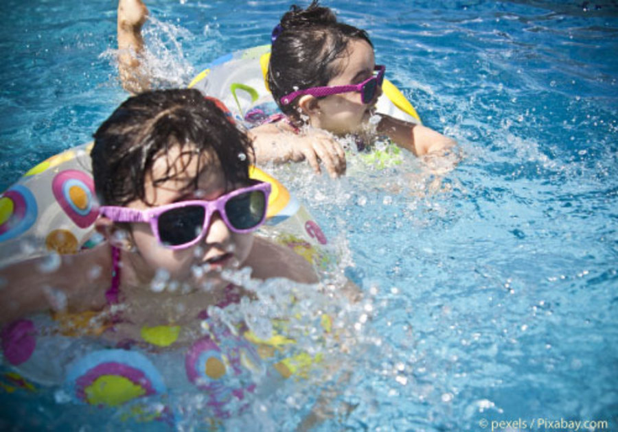 Kids swimming in pool wearing sunglasses