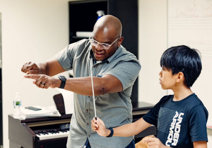 boy being taught how to conduct