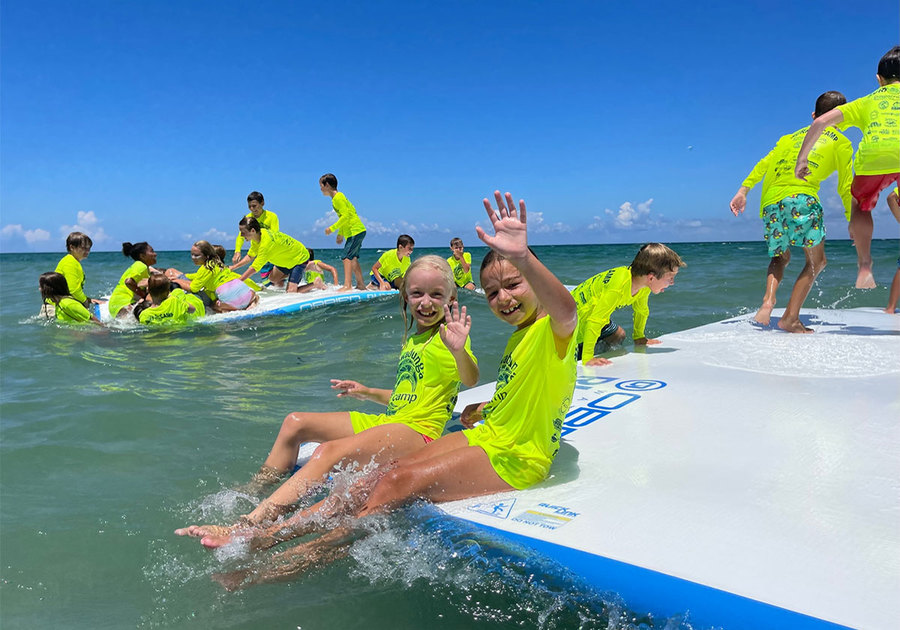 Cowabunga Surf & Watersports Summer Camp surfers waving