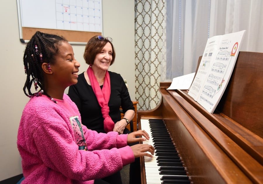 student and teacher practicing piano together at Colorado Music Institute