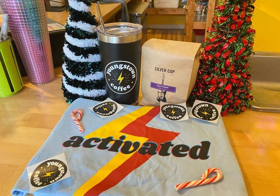 An assortment of Youngstown Coffee merch including shirt, thermos, and coffee beans