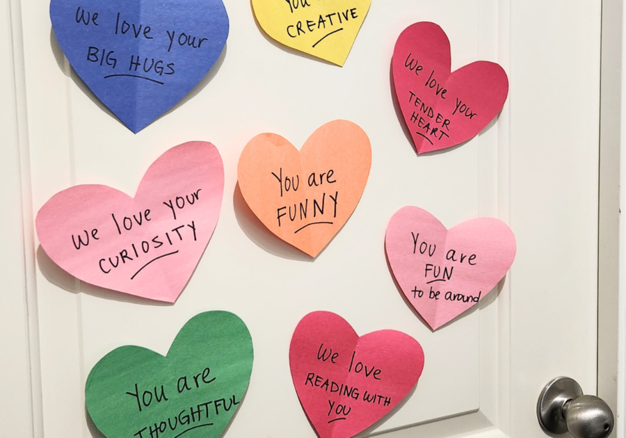 photo of colorful heart with black marker writing stuck to door