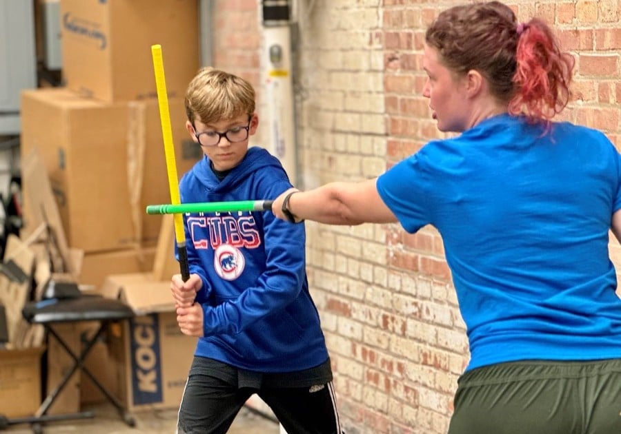 teacher and student dueling with light sabers