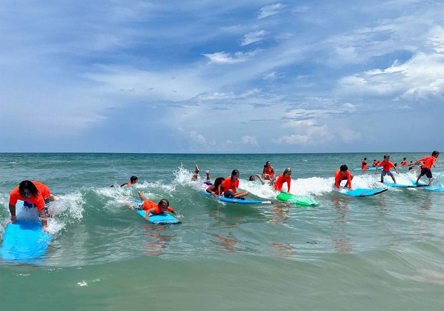 Kids surfing at Cowabunga Surf Camp 2024