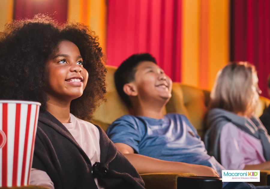 Happy kids watching movie in theatre