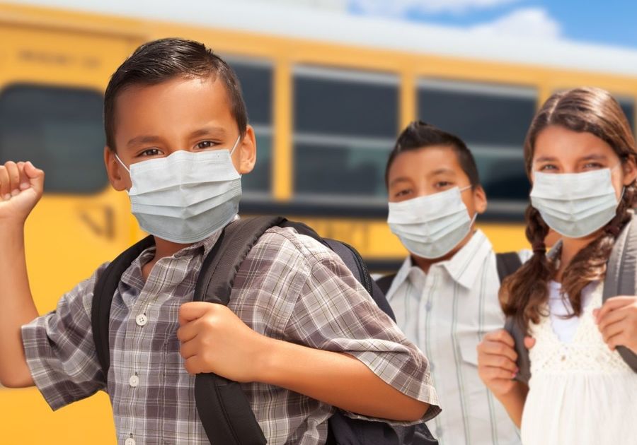 school bus children excited wearing masks